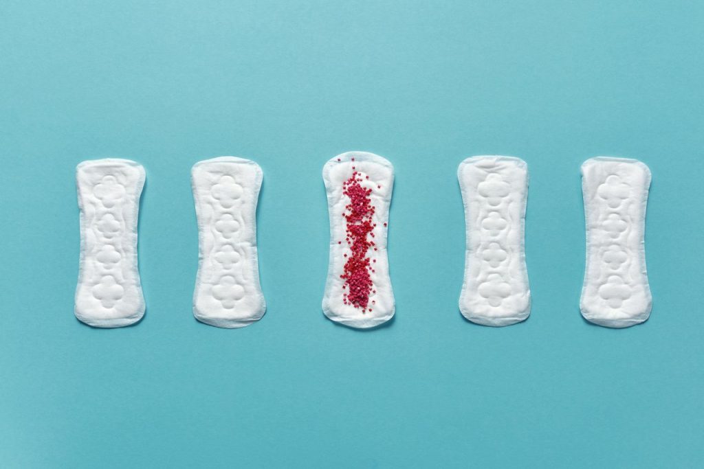 Five pantyliners on a blue background illustrating menstruation hygiene.
